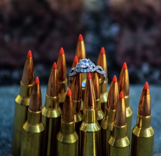 Kylie's engagement picture which shows her Princess cut engagement ring sitting on top of bullets. An odd picture for an odd family.