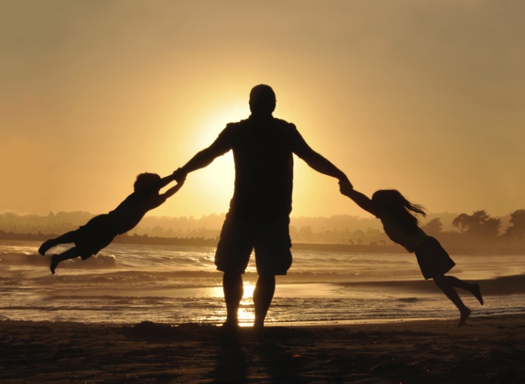 Father swinging his children